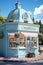 Beautiful display of flowers in a small storefront with a curved roof and lovely floral decorations