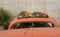 Beautiful display of succulents on the roof of a vintage orange car.