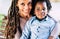 Beautiful diversity alternative family of black african people - mother and son smile in a portrait - trendy dreadlocks dredd hair