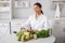 Beautiful doctor in a kitchen with a vegetables