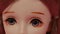 Beautiful doll. Close up. Portrait of attractive toy's face with big eyes.