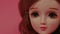 Beautiful doll with space for your text. Close up. Portrait of attractive toy's face with big eyes.