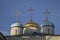 Beautiful domes of the old church against the blue sky. Crosses on the domes.