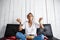 Beautiful domestic girl eating chips, watching tv, sitting at sofa.