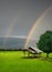 Beautiful Double rainbow on the sky verdant rice fields