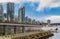 Beautiful downtown buildings and boats and seaplanes in Harbour of Vancouver, traveling tourists walking on promenade