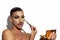 Beautiful drag queen applying makeup with white background