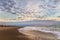 Beautiful dramatic cloudy sky over the wooden piles from the beach