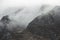 Beautiful dramatic Lake District landscape image of thick low cloud hanging over Illgill Head in wasdale Valley giving a very