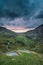 Beautiful dramatic landscape image of Nant Francon valley in Snowdonia during sunset in Autumn