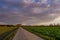 Beautiful dramatic orange and blue cloud and sky after storm over agricultural field.