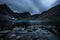 Beautiful Dramatic View of Rugged Mountains and Alpine Lake at Twilight