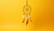 Beautiful dream catcher on yellow background