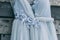A beautiful dress of gray hanging on a hanger on a wooden background