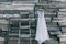 A beautiful dress of gray hanging on a hanger on a wooden background