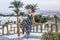 beautiful in dress looking at camera while leaning at wooden railing at resort in Egypt