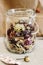 Beautiful dried flowers, different flavors, in glass jar on rust