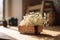 Beautiful dried flowers in glass jar on wooden tray on table indoors.