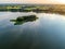 Beautiful drone aerial landscape photo of blue lake surrounded with green meadows and trees