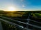 Beautiful drone landscape over lush farm fields and highways under sunset sky in Pennsylvania