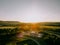 Beautiful drone landscape over lush farm fields and highways under sunset sky in Pennsylvania