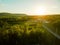 Beautiful drone landscape over lush farm fields and highways under sunset sky in Pennsylvania