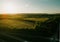 Beautiful drone landscape over lush farm fields and highways under sunset sky in Pennsylvania