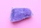 Beautiful druse of natural purple mineral amethyst  on a pink background. Large crystals of precious stones