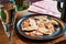 Beautiful dumplings with sour cream on a black plate on a table in a restaurant