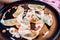 Beautiful dumplings with sour cream on a black plate on a table in a restaurant