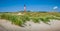 Beautiful dune landscape with traditional lighthouse at North Sea