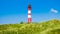 Beautiful dune landscape with traditional lighthouse at North Sea, Germany