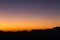 Beautiful dusk over profiles of mountains with orange and purple