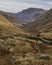 Beautiful early morning Winter landscape view of road cutting through Lake District countryside towards Brothers Water through the