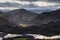 Beautiful early Winter morning landscape view from Latrigg Fell in Lake District across Dewentwater towards Little Town and