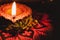 Beautiful earthen lamp in Diwali with Red Rangoli design and flowers  Devotion and Diwali concept