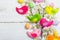 Beautiful Easter background with traditional decor. Flowers, decorative eggs, birds and rabbits