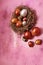 Beautiful Easter eggs on a pink shiny background.