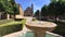 Beautiful el Salvador Chapel in Ubeda, Spain, reflected on the fountain water, surrounded by orange trees, Spain