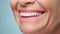 Beautiful elder womans smile with healthy white, straight teeth close-up on light background with space for text