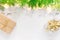 Beautiful elegant Christmas New Year background. White stars sparkling golden lights garland green juniper gift boxes on wood