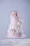 Beautiful elegant four tiered pink wedding cake decorated with roses flowers. Concept floral from sugar mastic