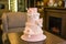 Beautiful elegant four tiered pink wedding cake decorated with roses flowers. Concept floral from sugar mastic