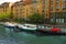 Beautiful elegant houses on the embankment, river, ships. City summer landscape.