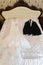 Beautiful and elegant white wedding dress and man groom wedding suite hanging on a wardrobe in anticipation of the celebration of