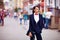 Beautiful elegant woman posing on crowded city street