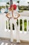 Beautiful, elegant woman in a white suit posing on the background of the caribbean palms