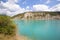 Beautiful emerald green water of Lake Castillon reflects the sky