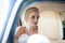 Beautiful emotional blonde bride posing in luxury car, face closeup