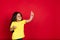 Beautiful emotional little girl isolated on red background. Half-lenght portrait of happy child gesturing